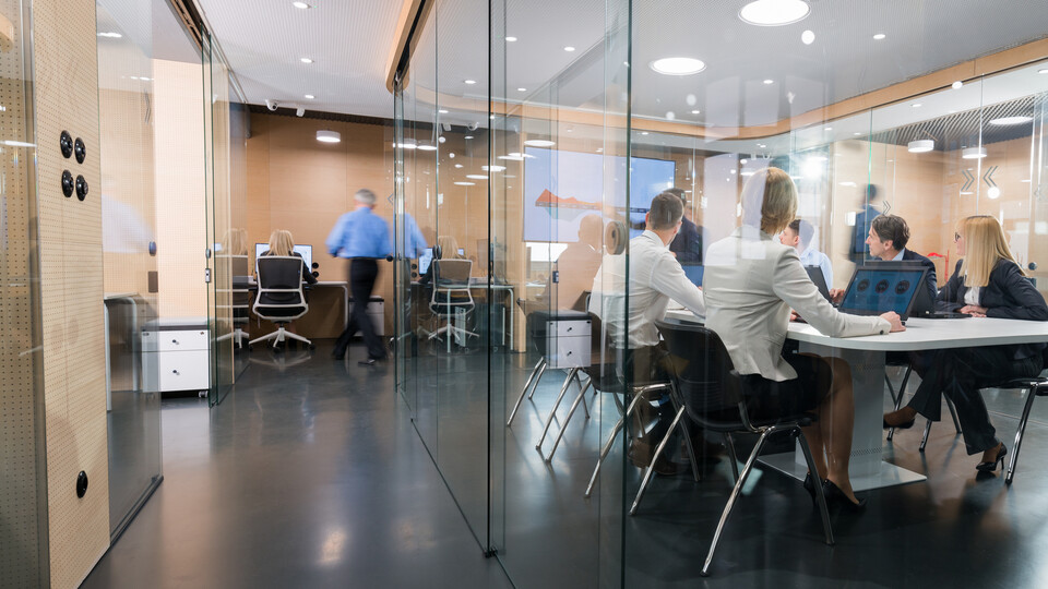professionals working on a modern office glass walls office